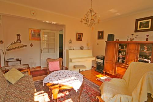 a living room with a couch and a table at De Nachtegaal in Eláfion