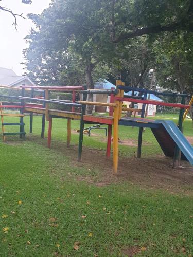 a group of park benches with a slide at Caribbean Estates Villa Raiya- First choice !!! 4 bedrooms with ensuite bathrooms in Port Edward
