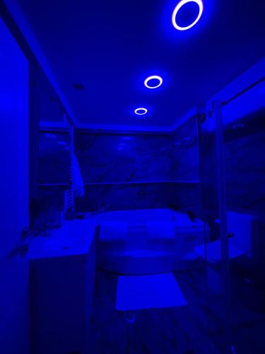 a dark room with a blue light on the ceiling at Suite In City Center in Tirana