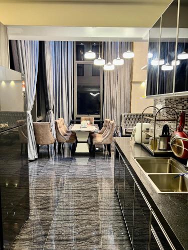a kitchen with a table and a living room at Bangi Evo Luxury Suite in Bandar Baru Bangi