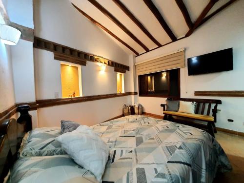 - une chambre avec un lit et une télévision dans l'établissement BETANIA Casa Hotel, à Ráquira