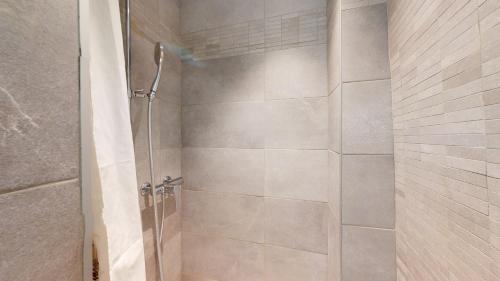 a shower with a glass door in a bathroom at Beautiful apartment in the heart of the old city in Sion