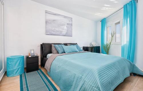 a bedroom with a bed with a blue comforter at CT 190 - Pearl of Algaida I in Sitio de Calahonda