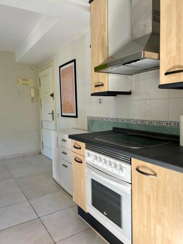 a kitchen with a white stove top oven at Aura Apartment Benidorm in Benidorm