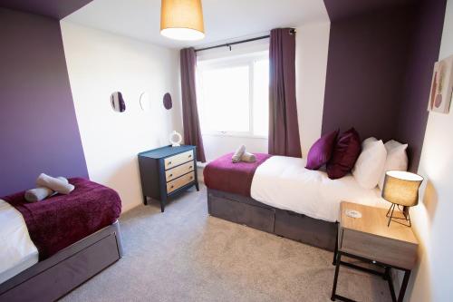 a bedroom with two beds and a window at Ideal Home Away in Whitefield Bury in Manchester