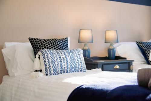 a bedroom with two beds with blue and white pillows at Ideal Home Away in Whitefield Bury in Manchester