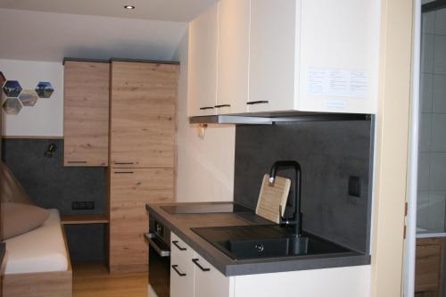 a kitchen with a sink and a counter top at Haus Bergliebe in Schladming
