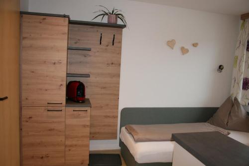 a bedroom with a bed and a wooden wall at Haus Bergliebe in Schladming