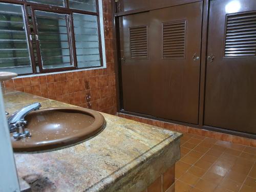 a bathroom with a sink and two doors at Santiago Dc Hostal in Cali