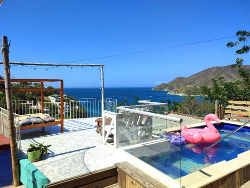 a swimming pool with a pink flamingo in the water at Tayrona Colors Hostel in Taganga