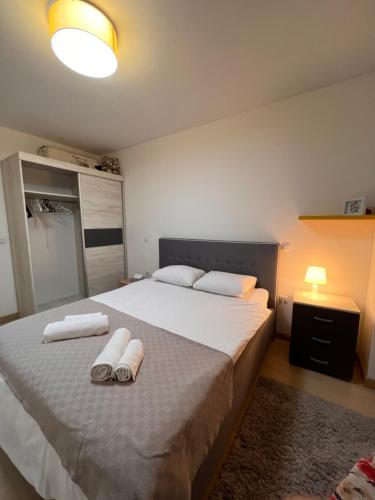 1 dormitorio con 1 cama grande y toallas. en Modern Flatiron Apartment, Skopje Center, en Skopje