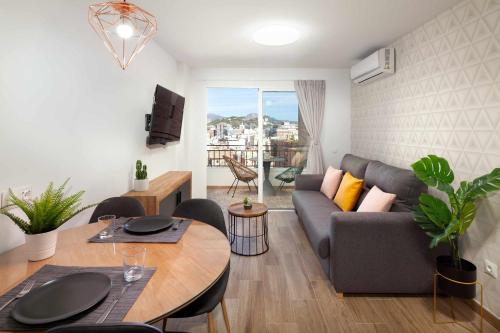 a living room with a couch and a table at Mirador La Catedral in Málaga