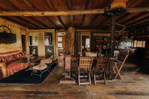 a living room with a couch and a table and chairs at Cabañas en el Bosque a 5 minutos del mar - Estancia CH in Punta del Este