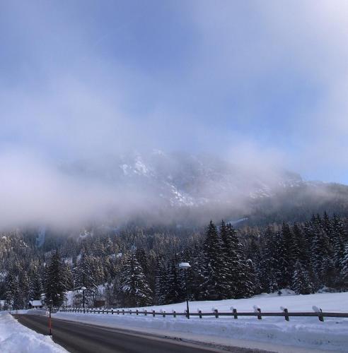 a snowy road with a mountain in the background at Haus Bergwelt in Grän