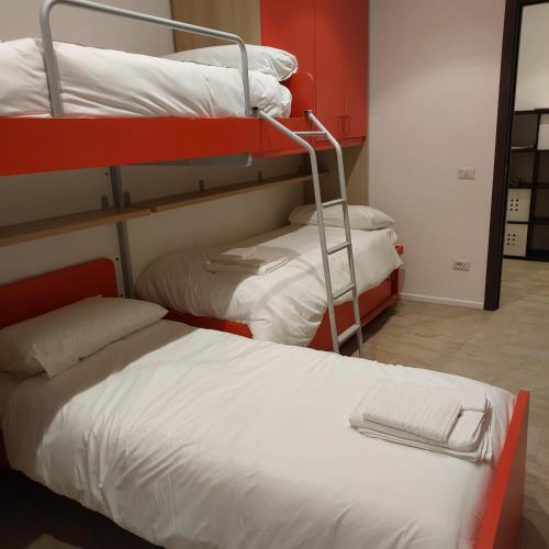 a room with three bunk beds and a mirror at ViaProperzio8 in Foligno