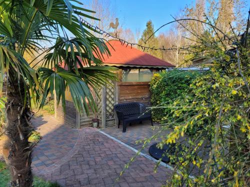 a bench sitting on a brick patio in a yard at Le Paddock Du Val De Lys in Blessy