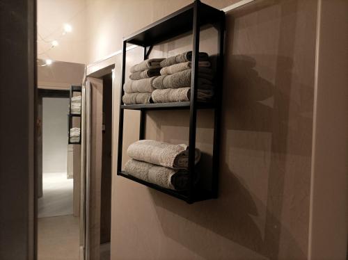 a towel rack with towels on a wall in a bathroom at La contrada in Cuneo
