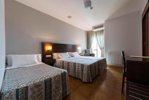 En eller flere senger på et rom på Hotel Troncoso