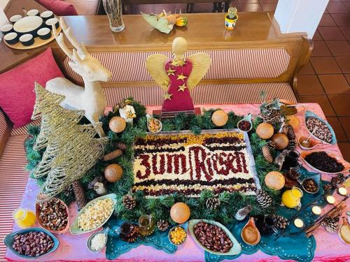 a cake on a table with food on it at Hotel & Restaurant Zum Riesen in Walldürn