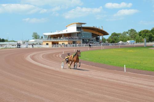 a horse is running on a race track at L' Ecume de Mer in Châtelaillon-Plage