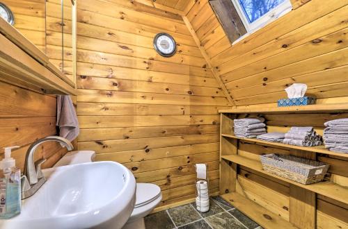a bathroom with a sink and a toilet in a log cabin at Cozy Yatesville Lake Cabin Rental in Louisa! in Louisa