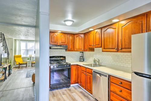 a kitchen with wooden cabinets and a stove top oven at The Gallery, an Allentown Retreat with Views! in Allentown