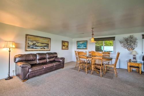 a living room with a leather couch and a table at Cliffside Lighthouse Beach Home with Ocean View in Coos Bay