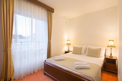 a bedroom with a bed and a large window at Villa Ljubanovic in Budva