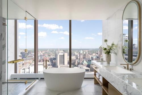 a bath tub in a bathroom with a large window at Four Seasons Hotel Minneapolis in Minneapolis