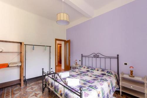 a bedroom with a bed with a metal bed frame at Il Glicine di Villa Vittoria nel verde a pochi minuti di auto dalle spiagge in Borgonovo