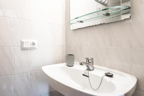 a white bathroom with a sink and a mirror at Green Park B18 in Son Parc