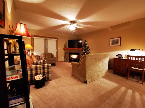 a living room with a christmas tree and a fireplace at Gorgeous House for Ski Retreat or Mountain Vacations in Snowshoe