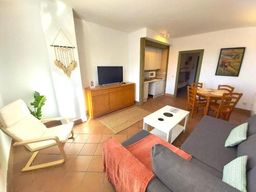 a living room with a couch and a table at Plaza Andalucía Edificio Salvia in Monachil