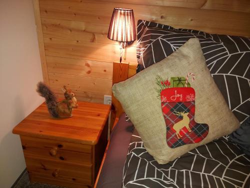 a bedroom with a bed with a christmas pillow on it at Hámori Álom in Miskolc
