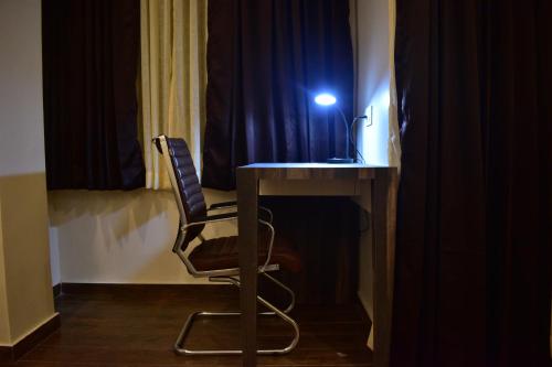 a room with a desk with a chair and a light at HOTEL MONTANA VYOO in Namchi