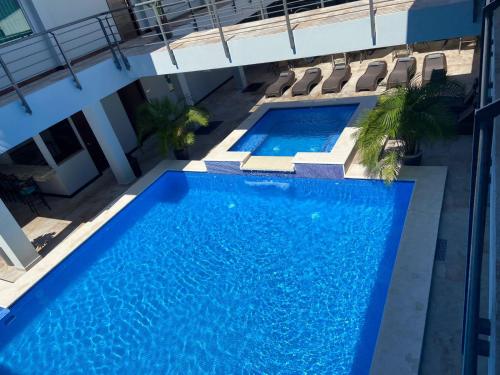 an overhead view of a swimming pool in a building at Hotel Cayuga in Puntarenas