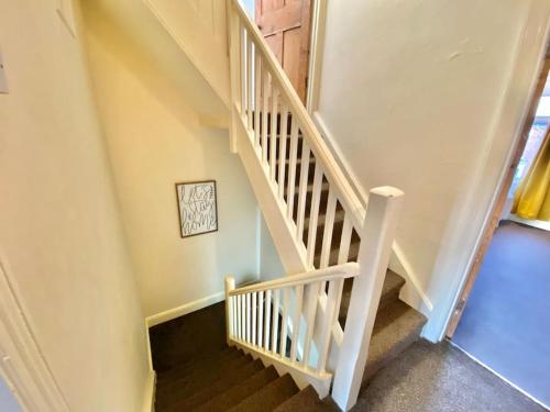a stairway with a white rail and a stair case at EasyRest House 2 Grantham - 6 Beds & Free Parking - Easy Location - Access to A1, Town Centre & Shops in Grantham