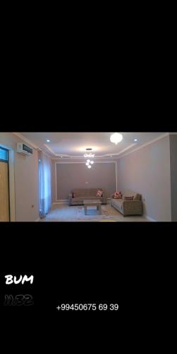 a living room with a couch and a table at Gabala rent House in Gabala