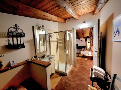 a bathroom with a glass shower and a sink at B&B Relais Cascina al Campaccio in Taino