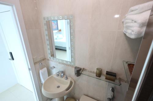 ein Bad mit einem Waschbecken und einem Spiegel in der Unterkunft Mejor que un Hotel in Salinas
