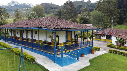 a blue and white house with a roof at El Rancho de Salento in Salento