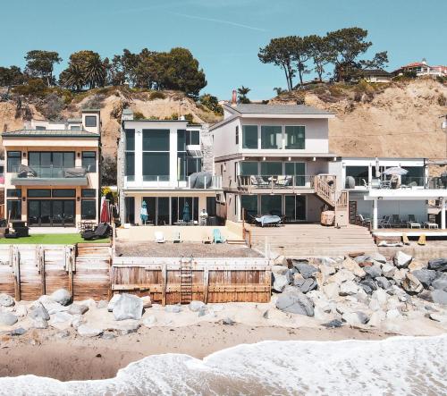 a house on the beach with rocks in front of it at OCEAN FRONT - STUNNING VIEWS- VACATION PARADISE!! in Dana Point
