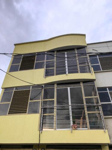 a person is looking out of the window of a building at Apartamento portal del prado in Santa Rosa de Cabal