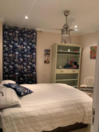 a bedroom with a large bed and a curtain at Camino del Faro LALBIR Alicante in Albir