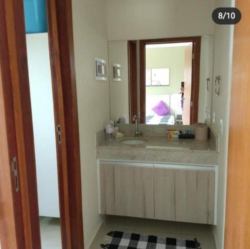 a bathroom with a sink and a mirror at Flat_Quartie_aldeia_das_aguas in Barra do Piraí