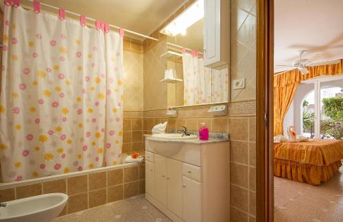 a bathroom with a sink and a shower curtain at Ona Los Claveles in Los Cristianos