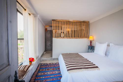 Ένα ή περισσότερα κρεβάτια σε δωμάτιο στο Kasbah Beldi