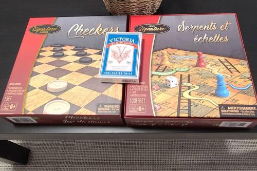 a board game on a table with two books at Cozy 2-bedroom lower unit! in Barrie