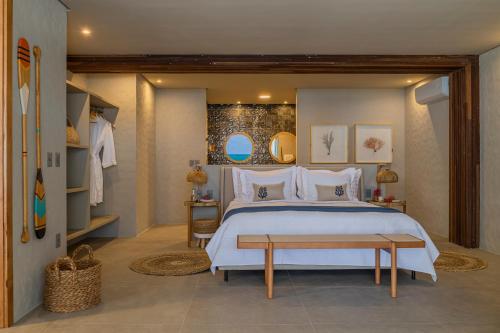 a bedroom with a large bed and a table at Saline Taíba Boutique Beach Hotel in Taíba