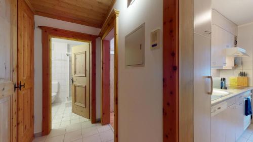a kitchen with a hallway leading to a bathroom at Abitaziun Ruinatsch 22 - St Moritz in St. Moritz